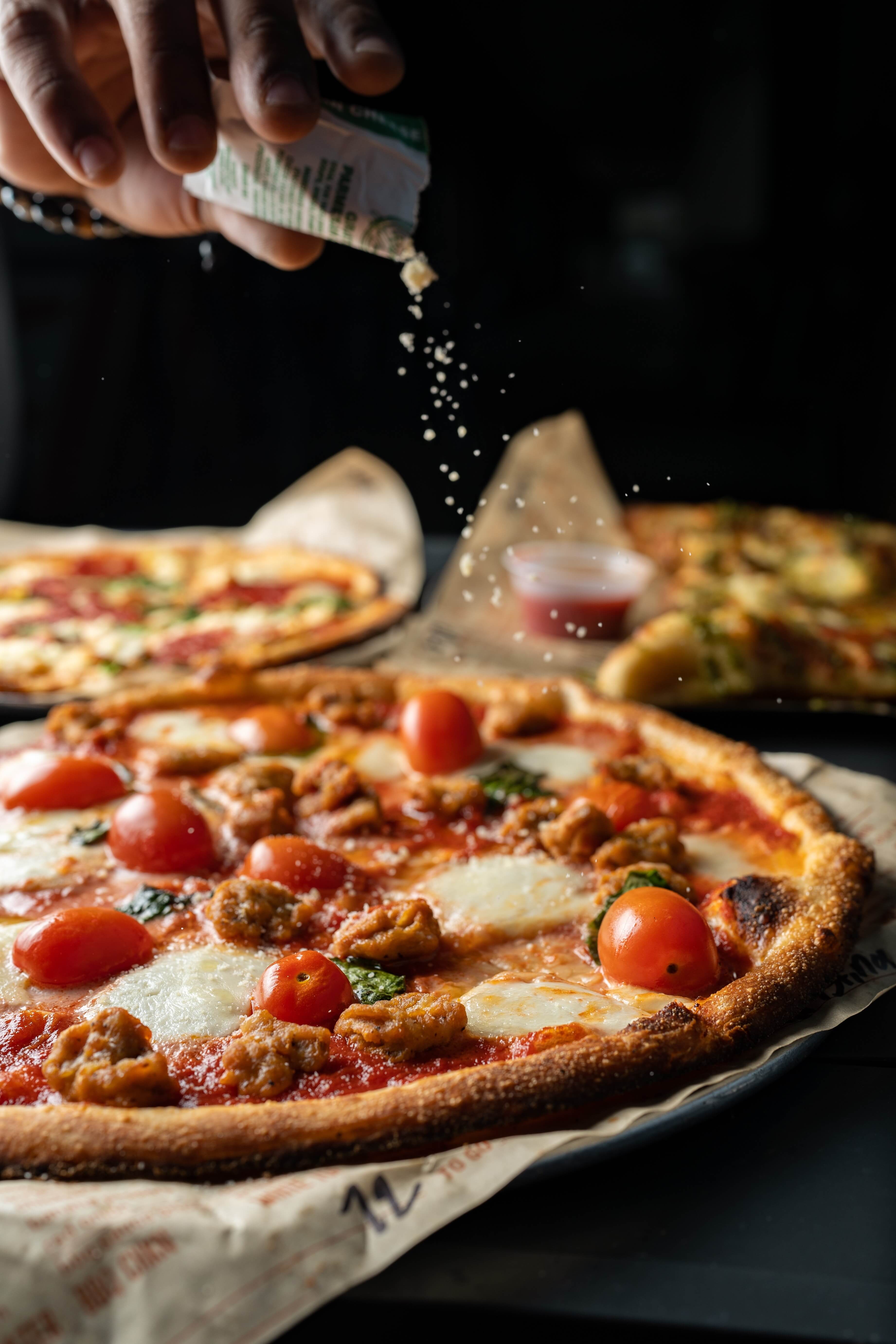 An image of italian pizza and fresh basil to represent pizza herbs online.