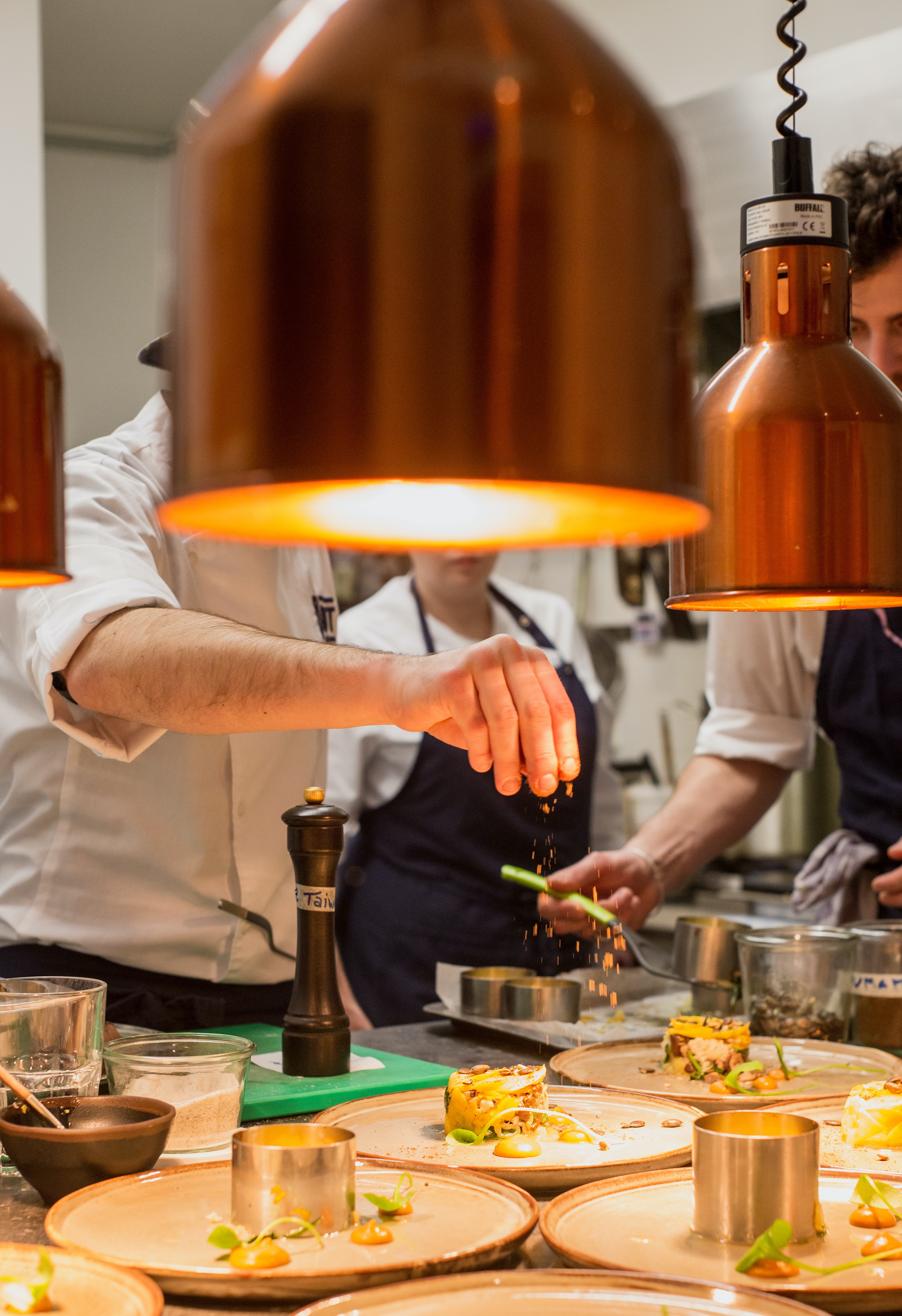 Chefs cooking with different herbs and spices to show their individual personality